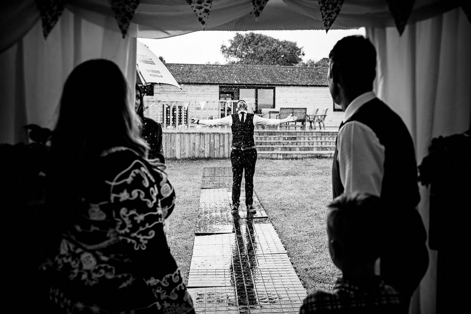 Groom enjoying the rain