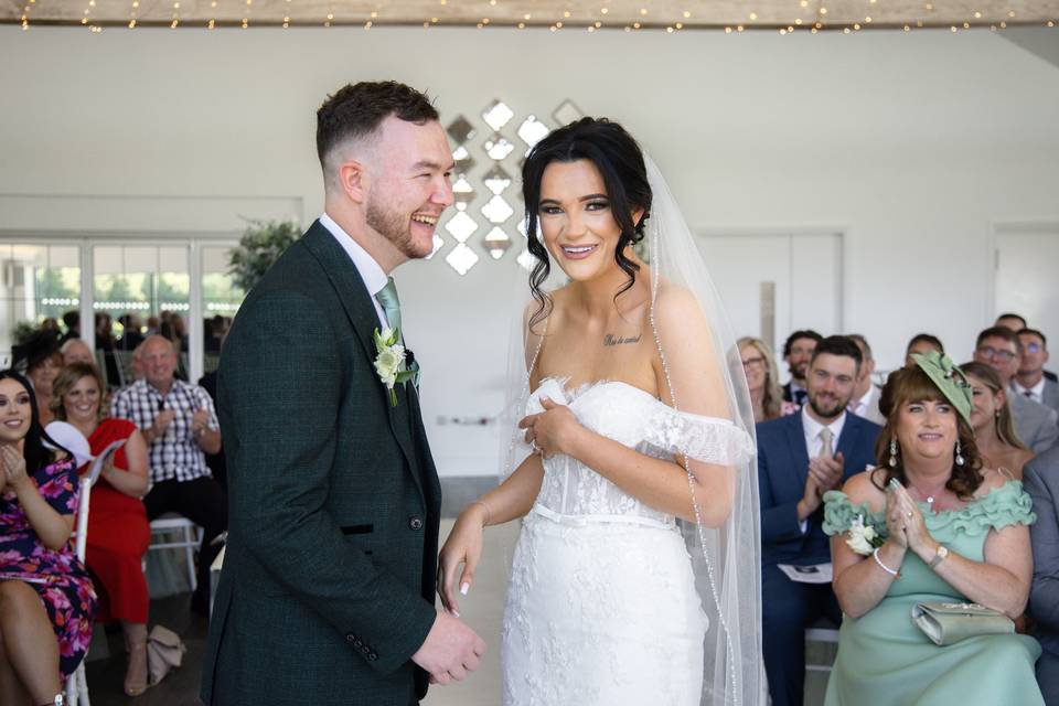 The briding groom laughing during their wedding ceremony