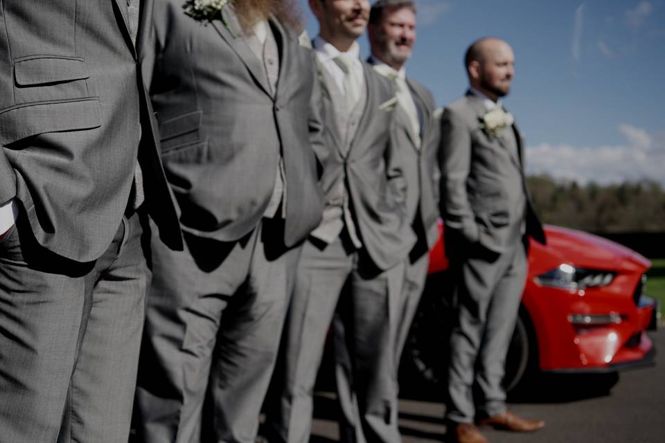Groomsmen next to Mustang