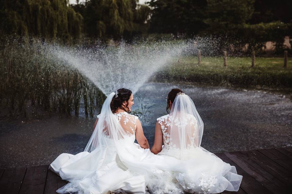 Brides sitting by fountain