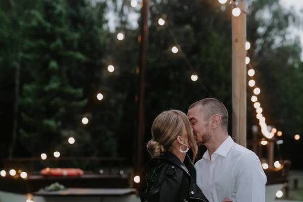 Kissing in front of lit boat