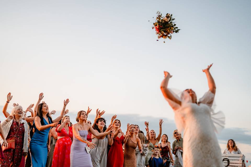 Ladies reach for brides boquet