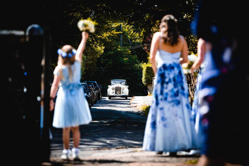 Flower girl greeting the newlyweds