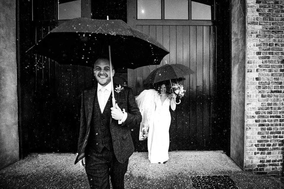 Bride and Groom caught in rain