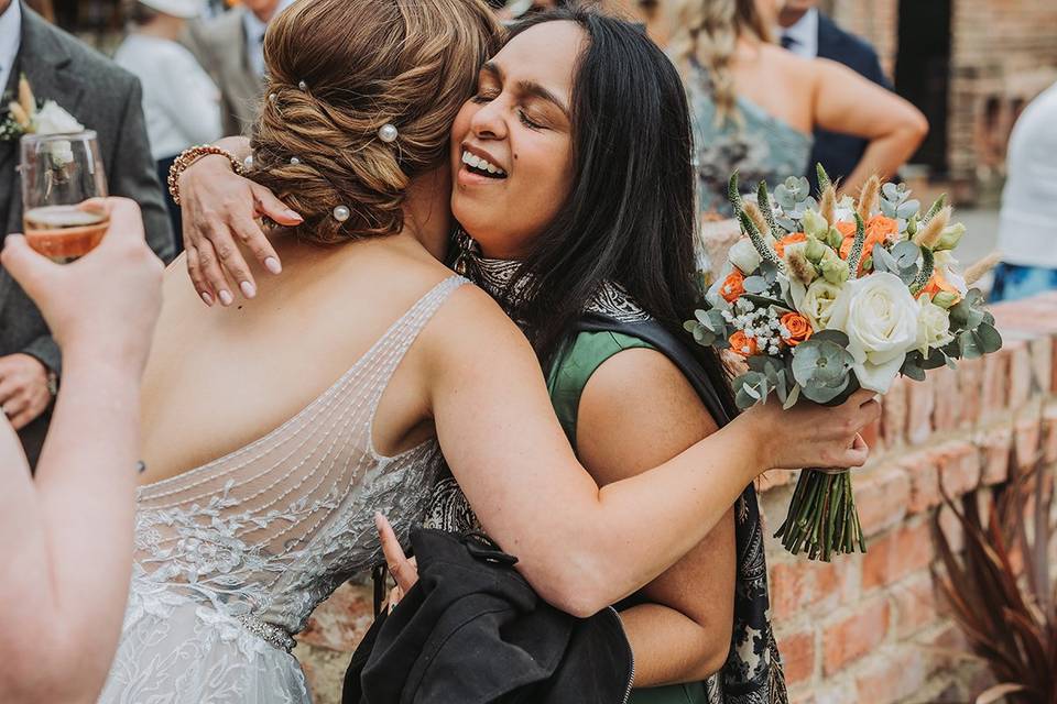 Guest hugs bride