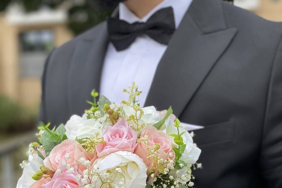 Groom holding bride's bouquet