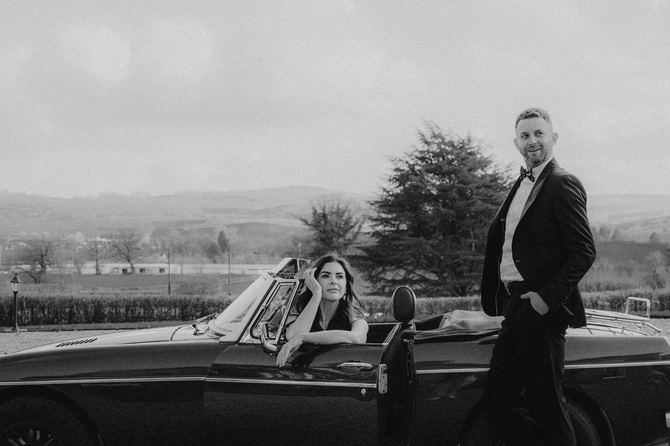 Couple with wedding car