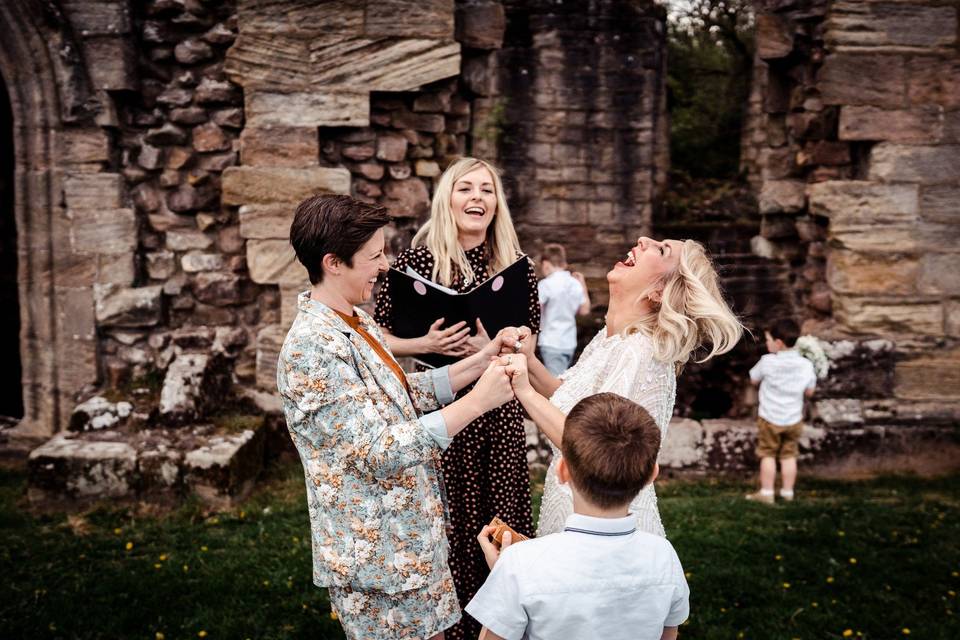 Couple laughing with celebrant