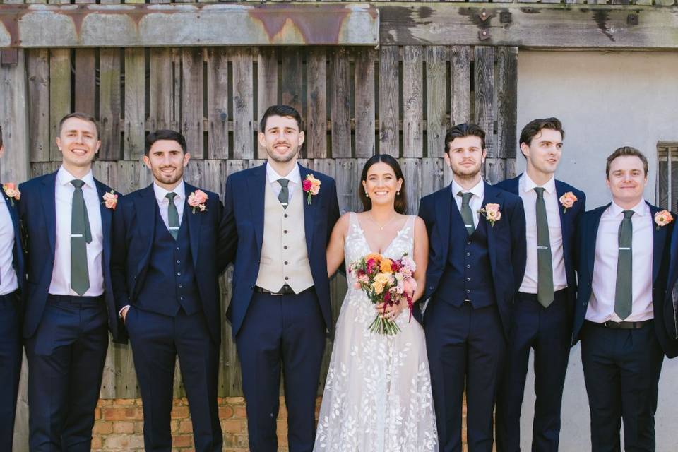 Photo of bride with groomsmen