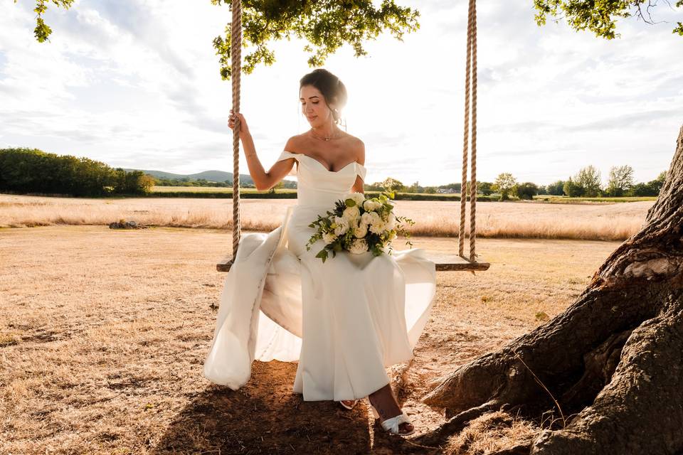 Bride elegantly sat on swing