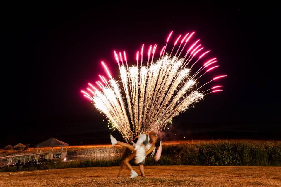 Big fireworks as couple kiss