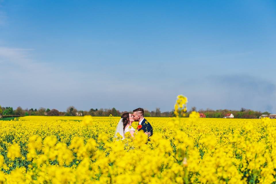 Bride and groom in field