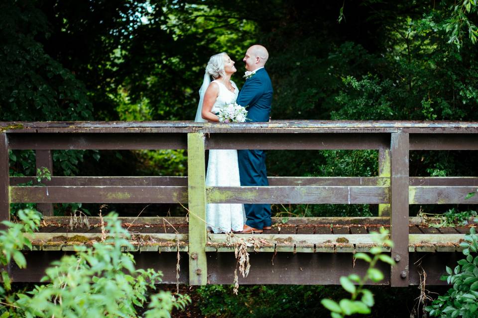 Newlyweds on a bridge