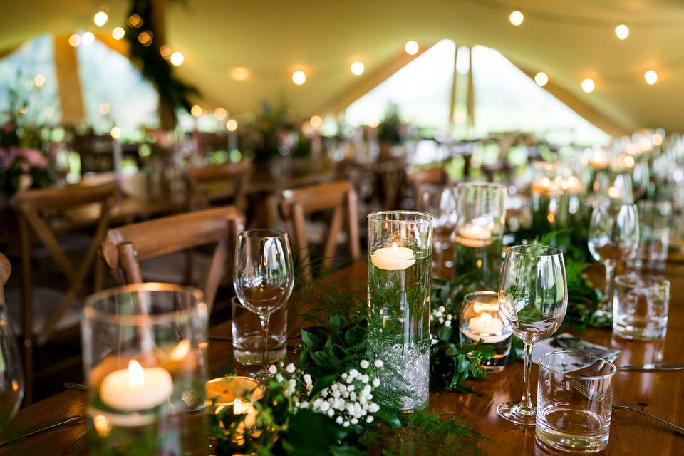 Rustic tables in stretch tent