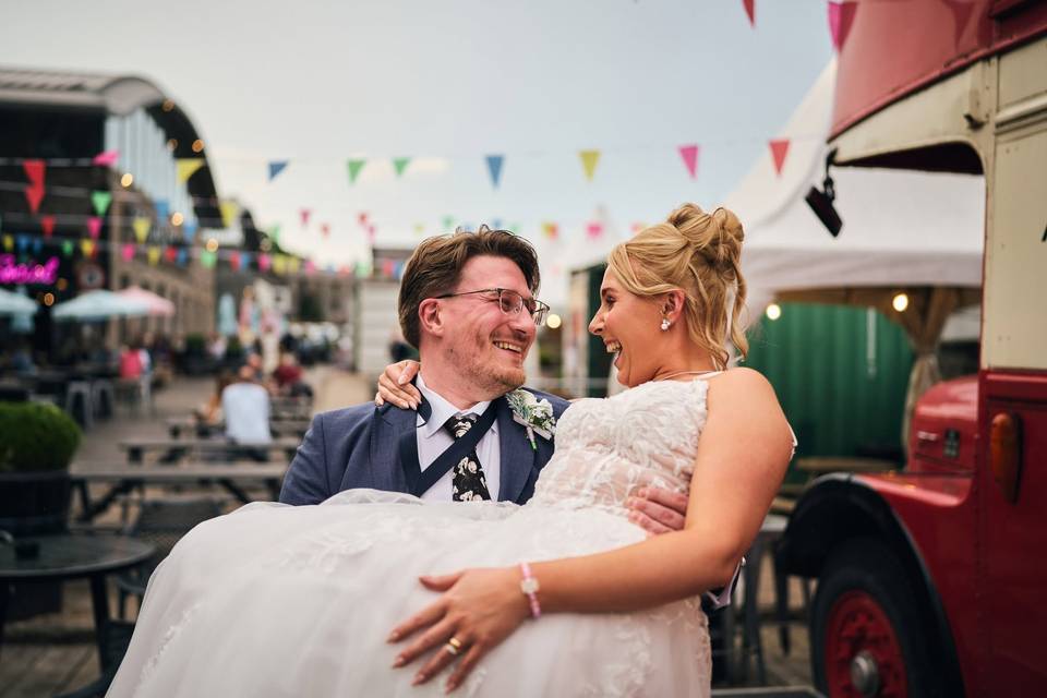 Groom carrying his new wife
