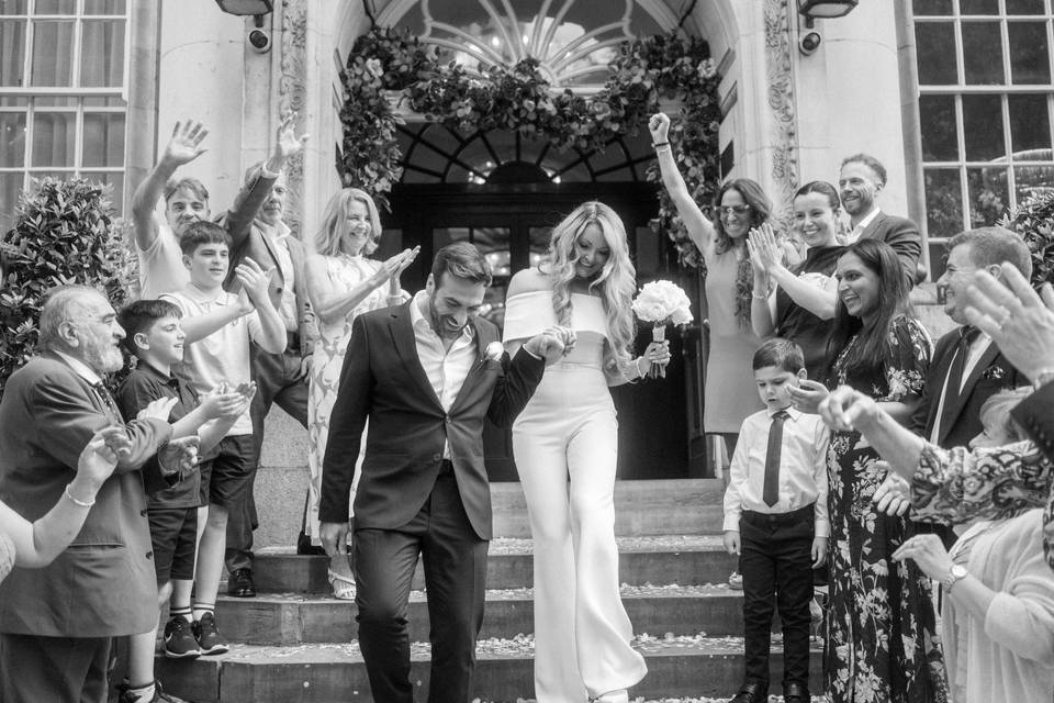 Bride and groom walk down step