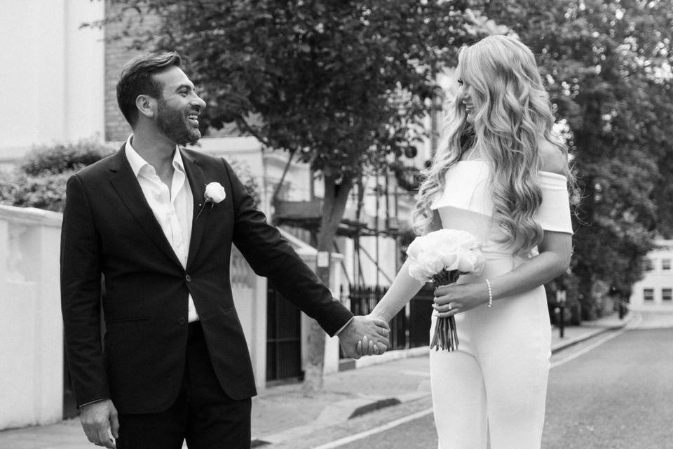 Bride and groom hold hands