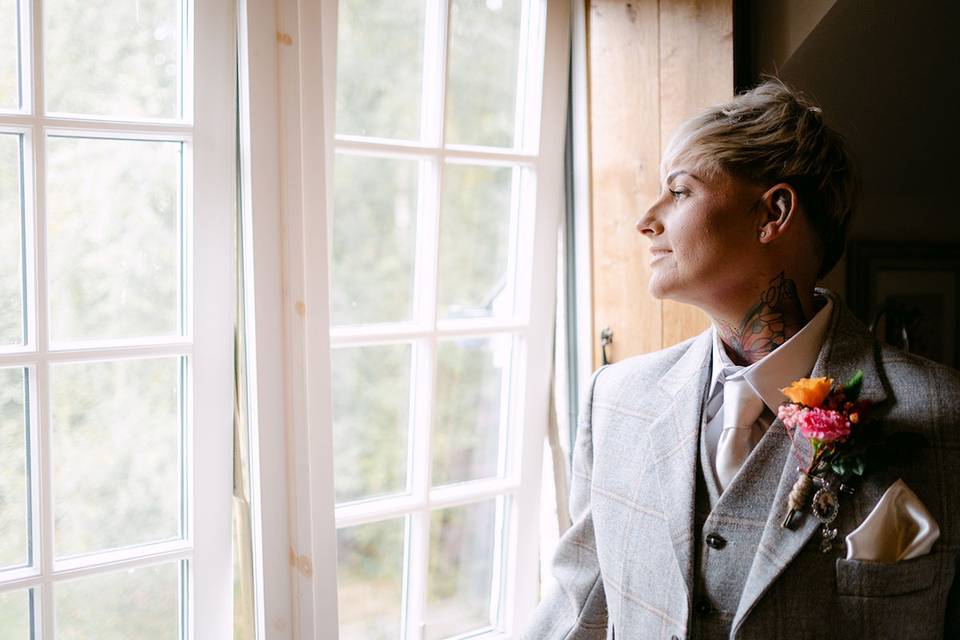 Bride looks out winder