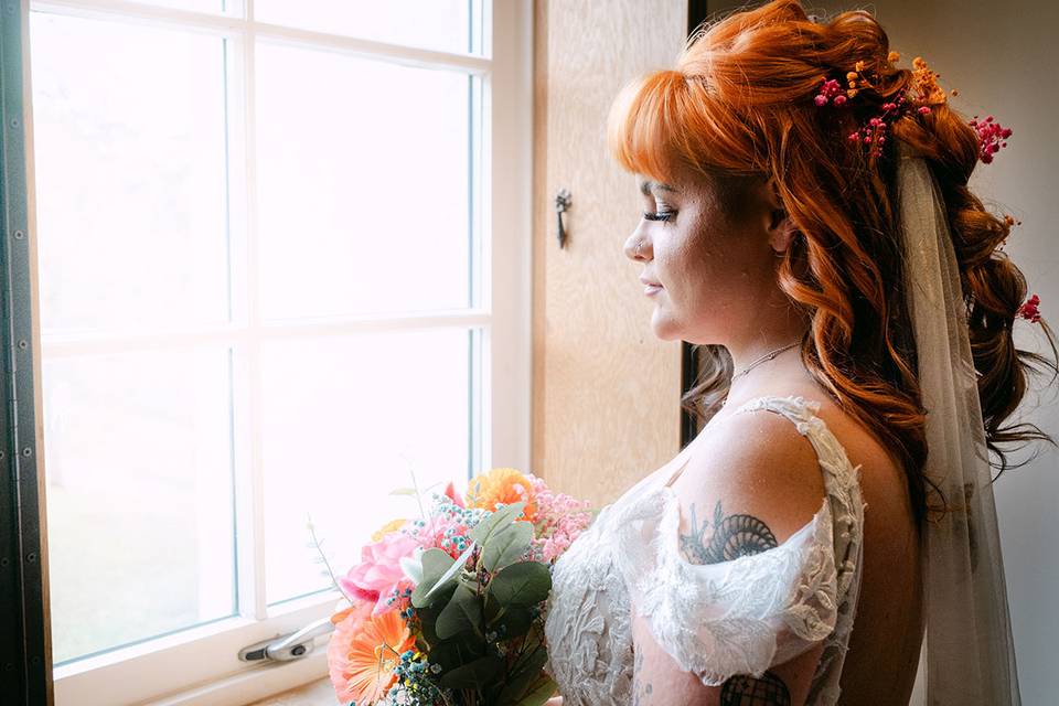 Bride looks at flowers