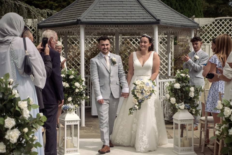 Couple depart down the aisle