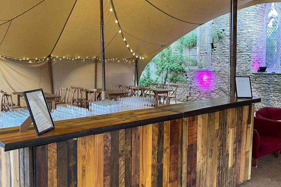 Wooden bar under stretch tent