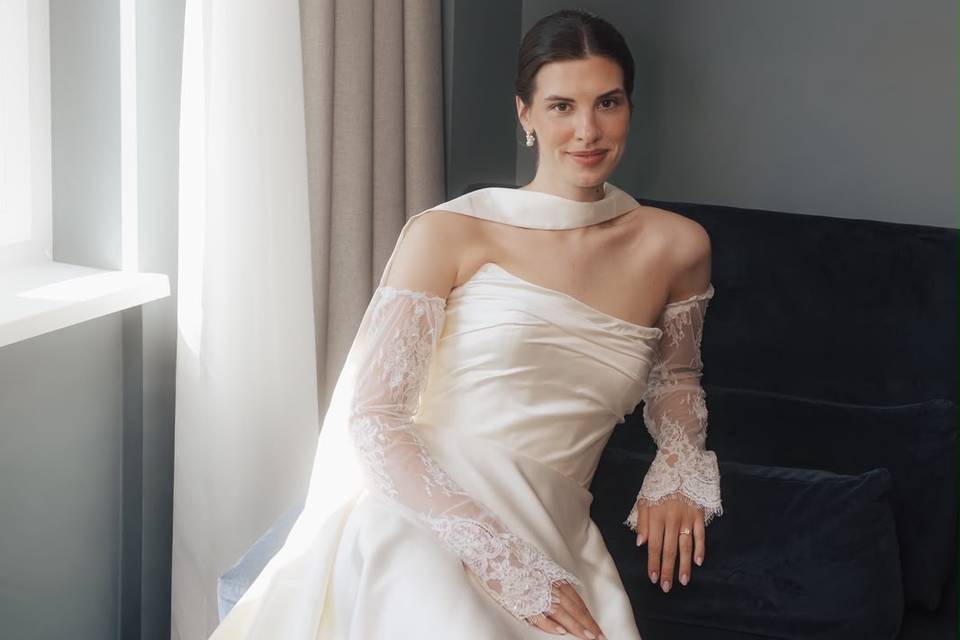 Draped bridal gown with lace sleeves