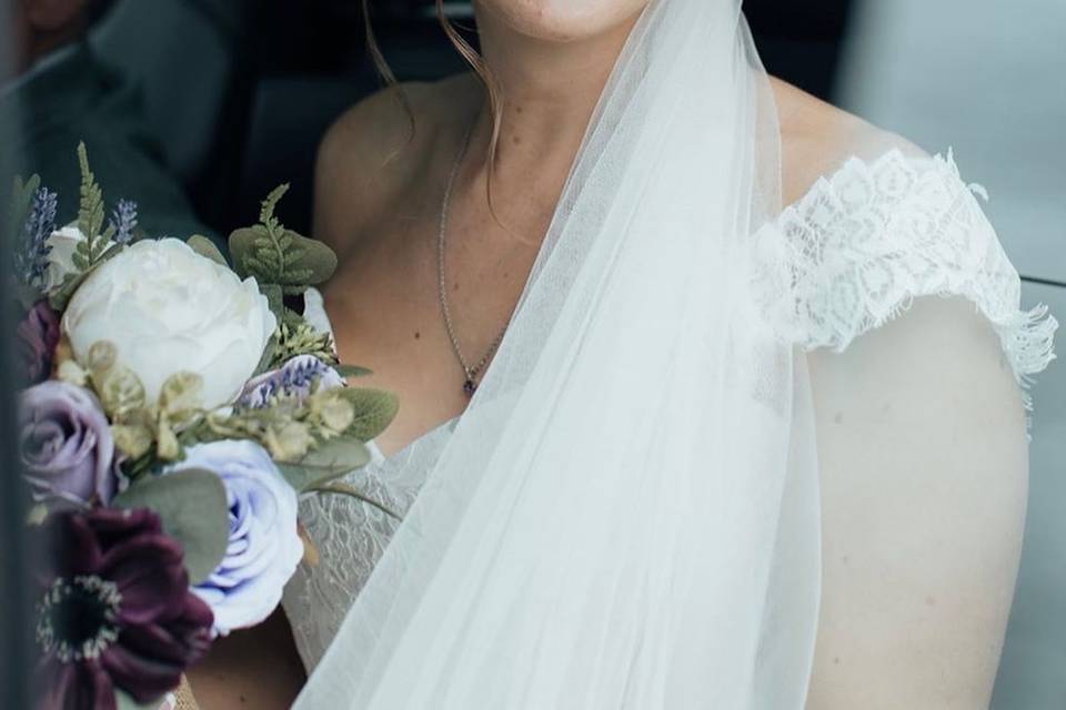 Bride hair and makeup in car