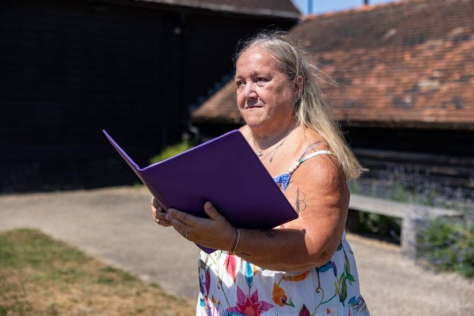 Reading from a purple ceremony folder