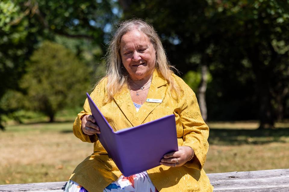 Smiling celebrant with ceremony folder