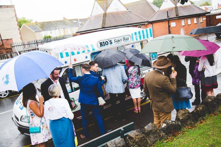 Wedding guests with umbrellas