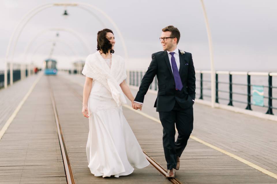 Couple walking down the pier