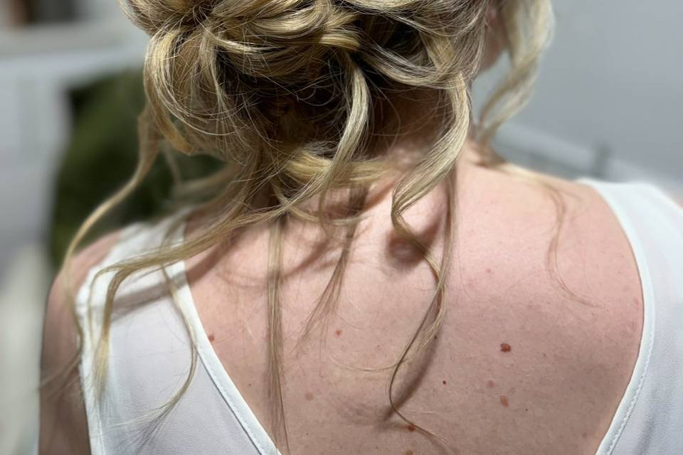 Tousled low bun with braid