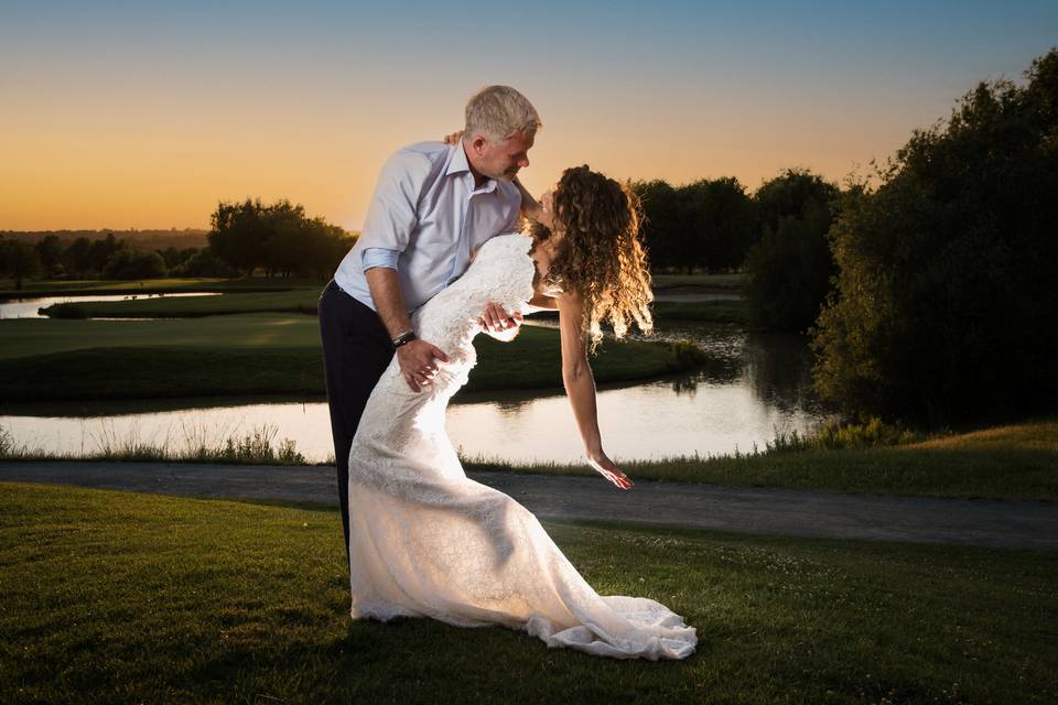 Groom Dips Bride at Sunset