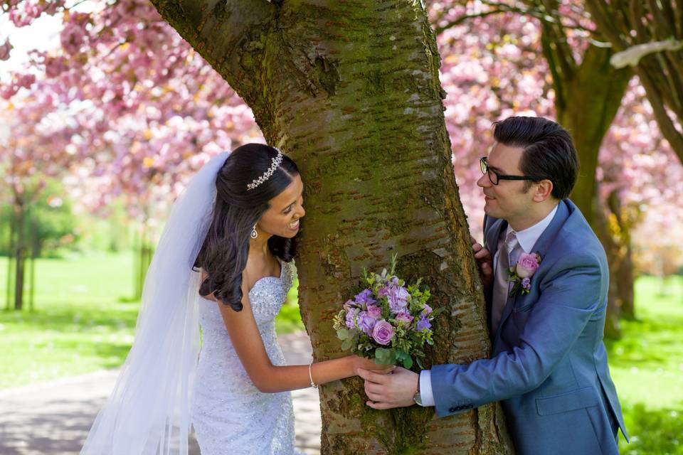 Bride and groom by the car