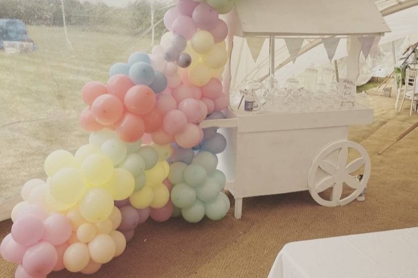 Balloons over candy cart