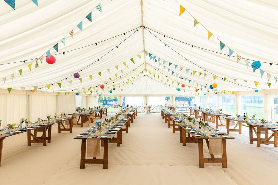 Marquee wedding with benches and bunting