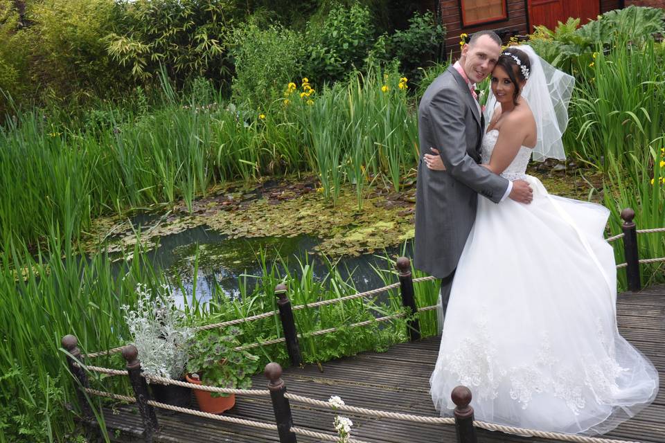 Bride and groom by the pond