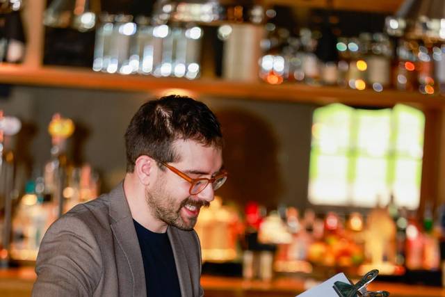 artist drawing guests near the bar