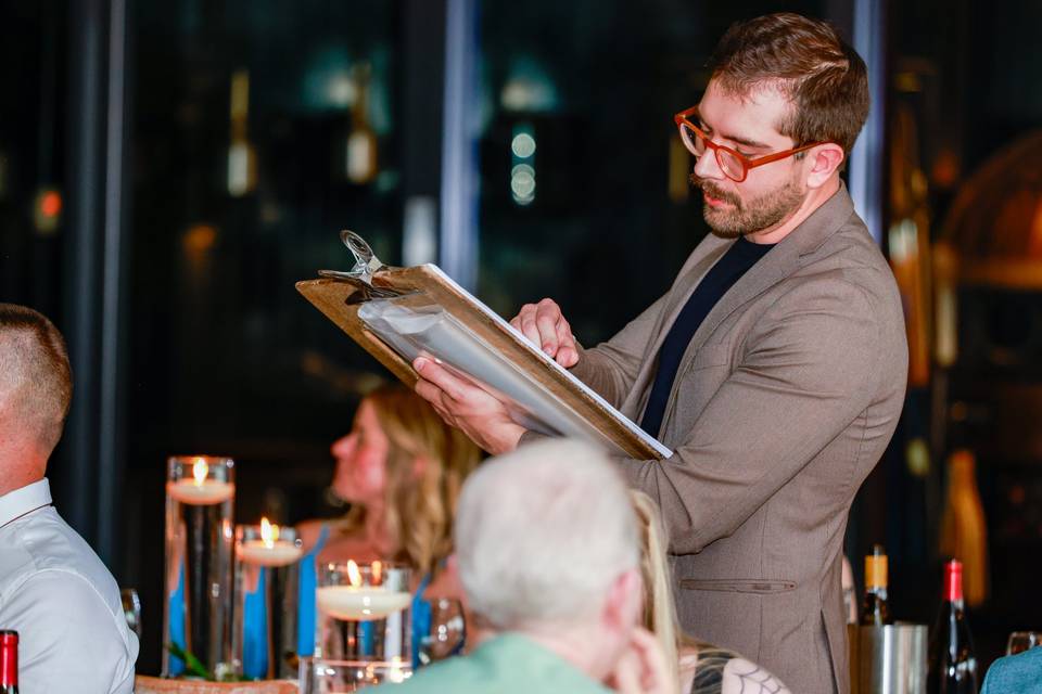 artist drawing guests during dinner