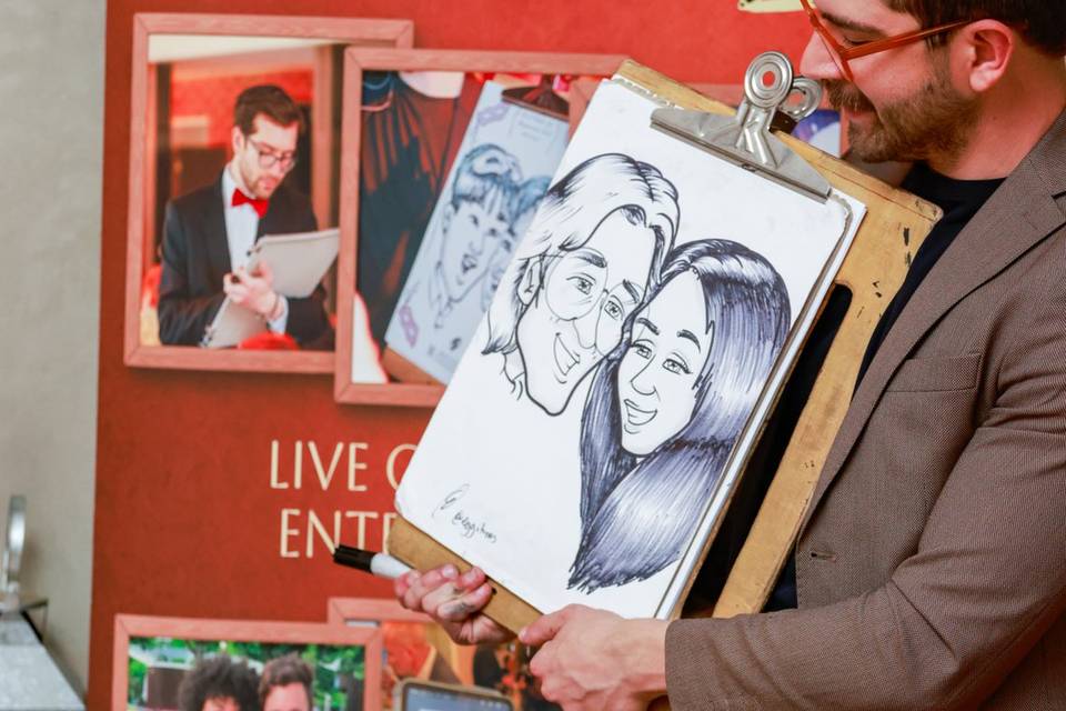 artist drawing next to a promotional poster