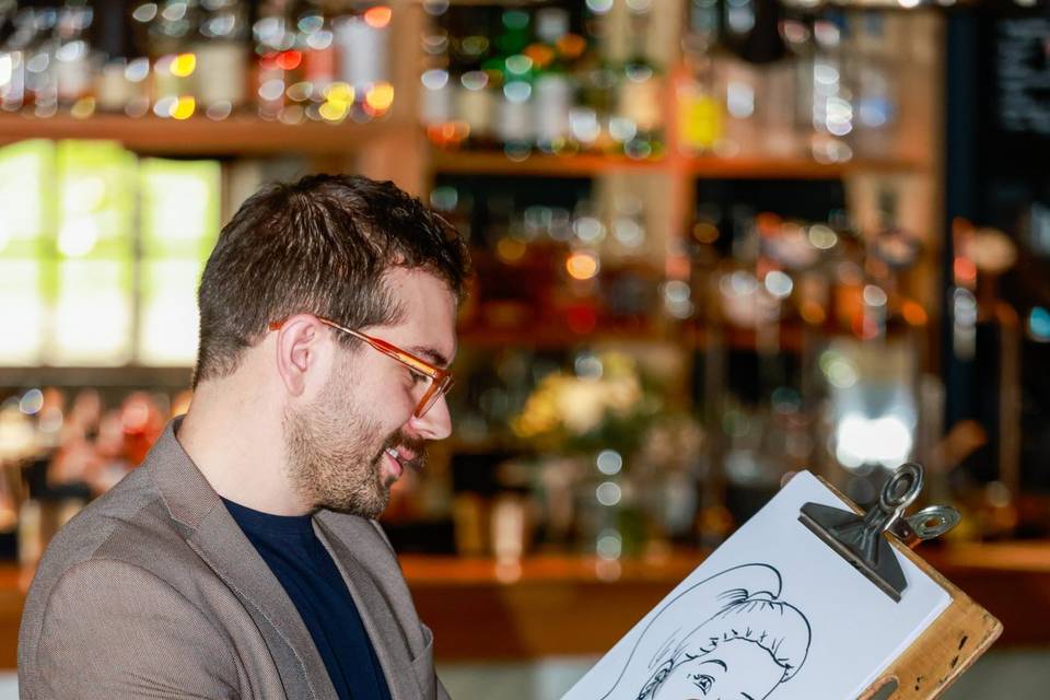 artist working on portrait in a bar