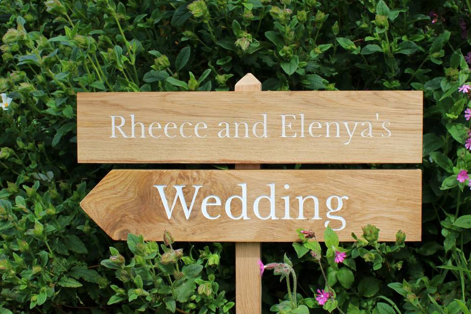 Wedding sign against shrubbery