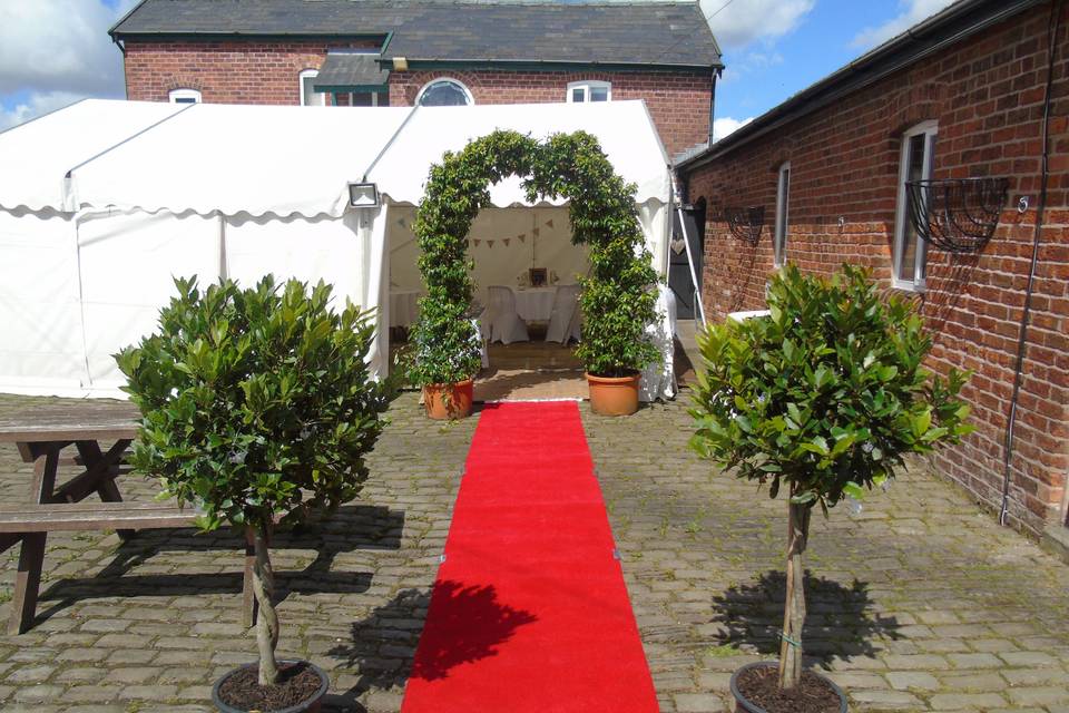 Red carpet and flower arch