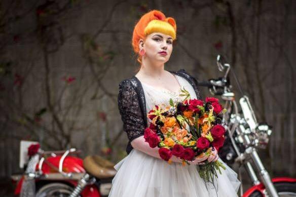 Bride standing in front of a motorbike