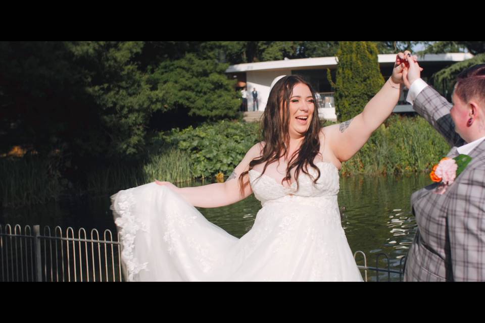 Couple twirl by the fountain