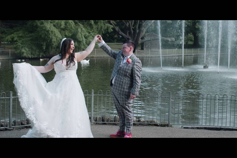 Couple twirl by the fountain