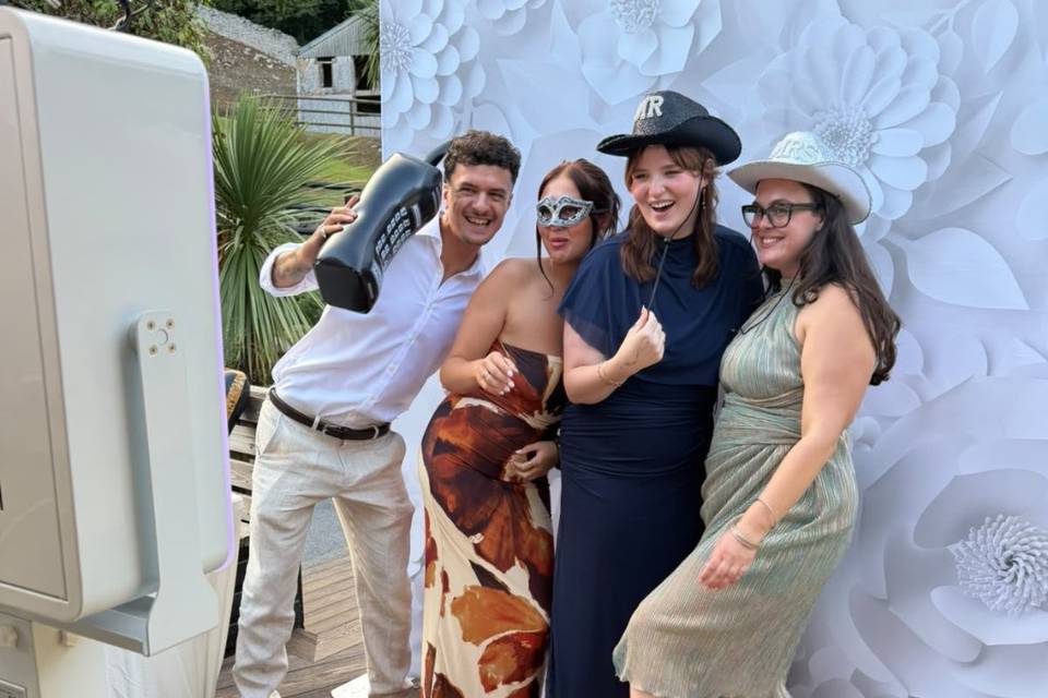 Wedding guests posing with photo booth props
