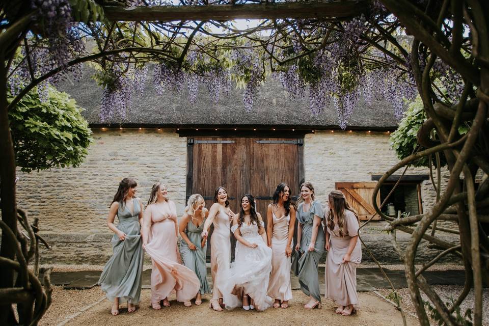 Bridesmaids dancing at barn