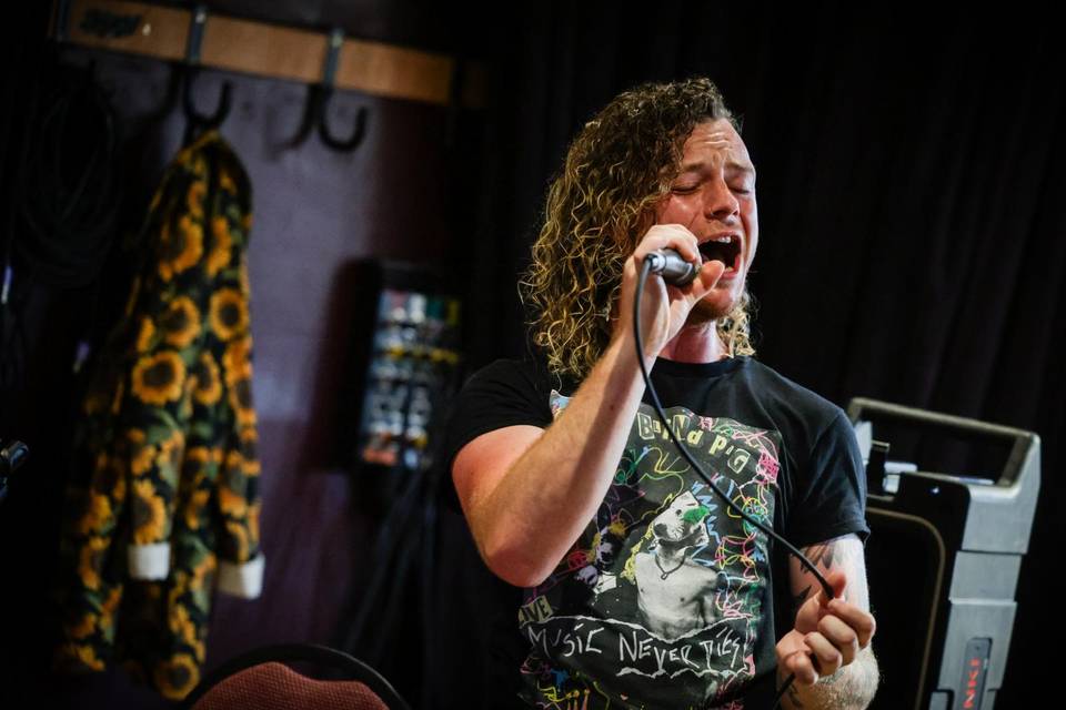 Singing alongside band