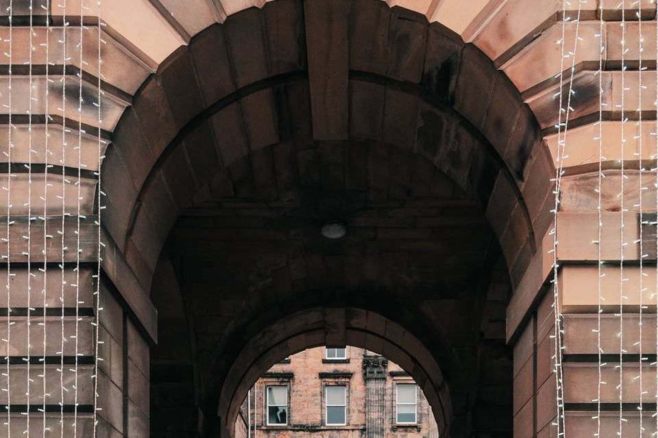 Newlyweds beneath arch